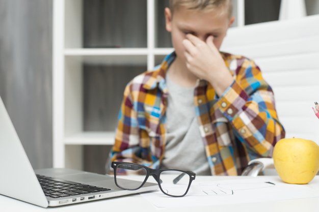 boy-with-laptop-desk-tired-expression_23-2148018961