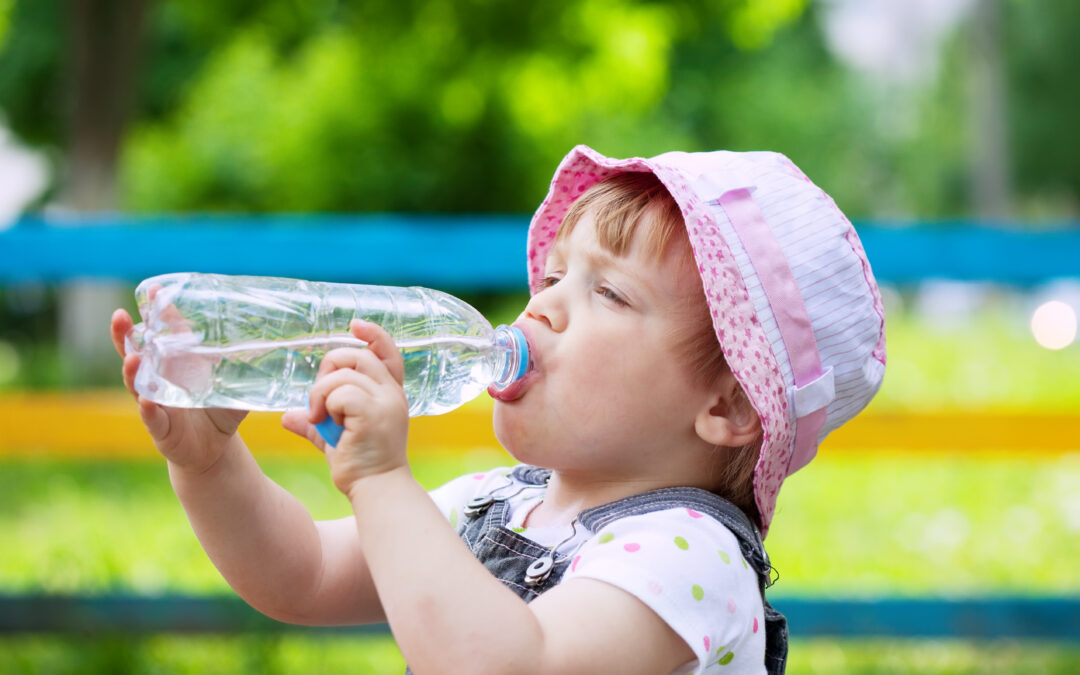 two-year child drinks from  bottle