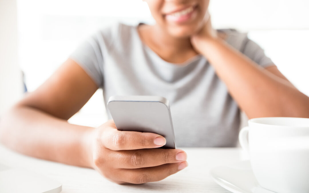 Close-up of African woman reading sms on phone