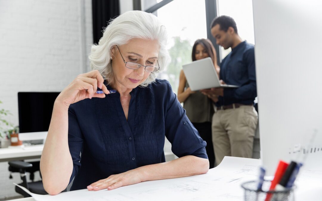 Mature businesswoman working with documents while sitting at her workplace